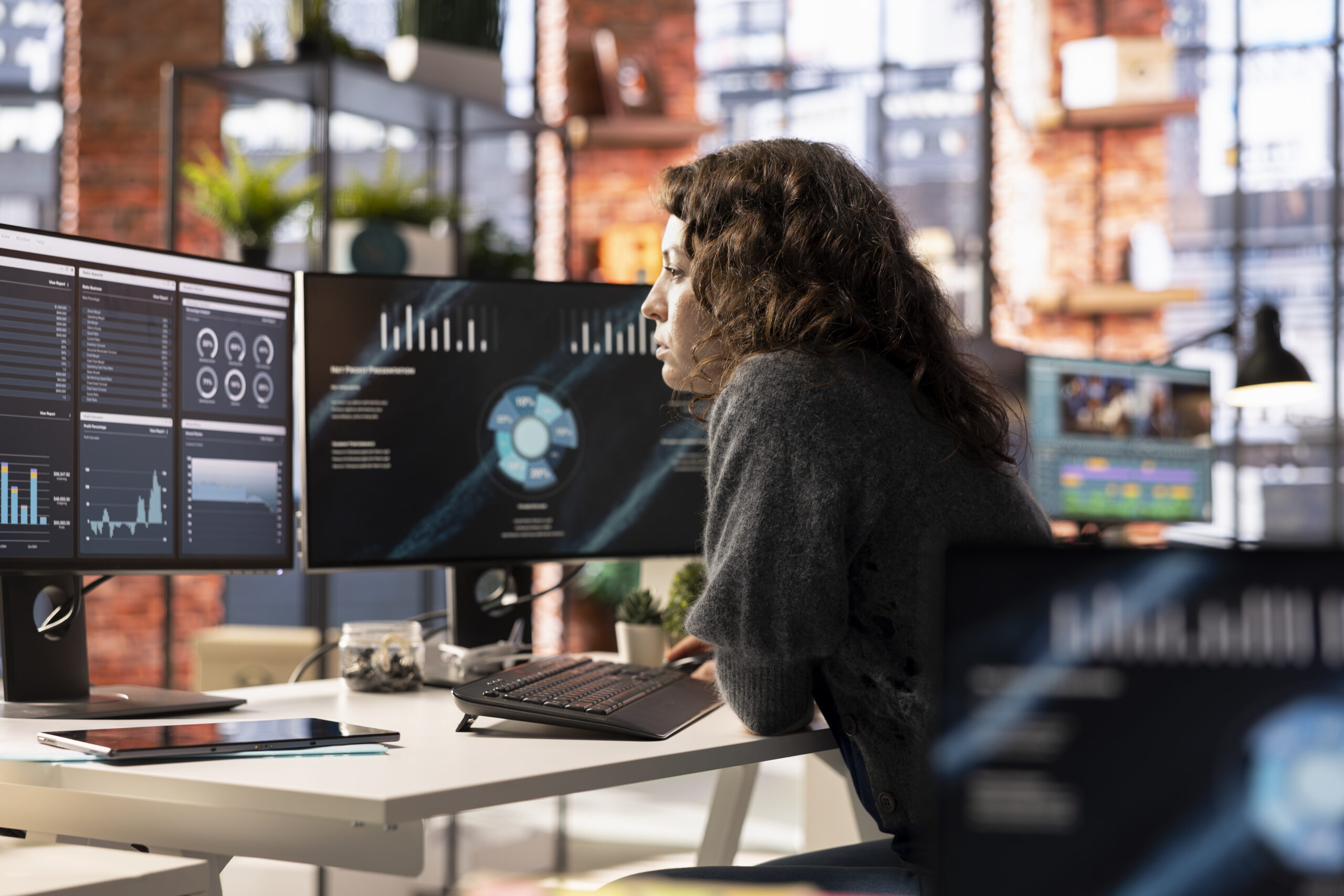 Young woman watching business conference infographics on computer